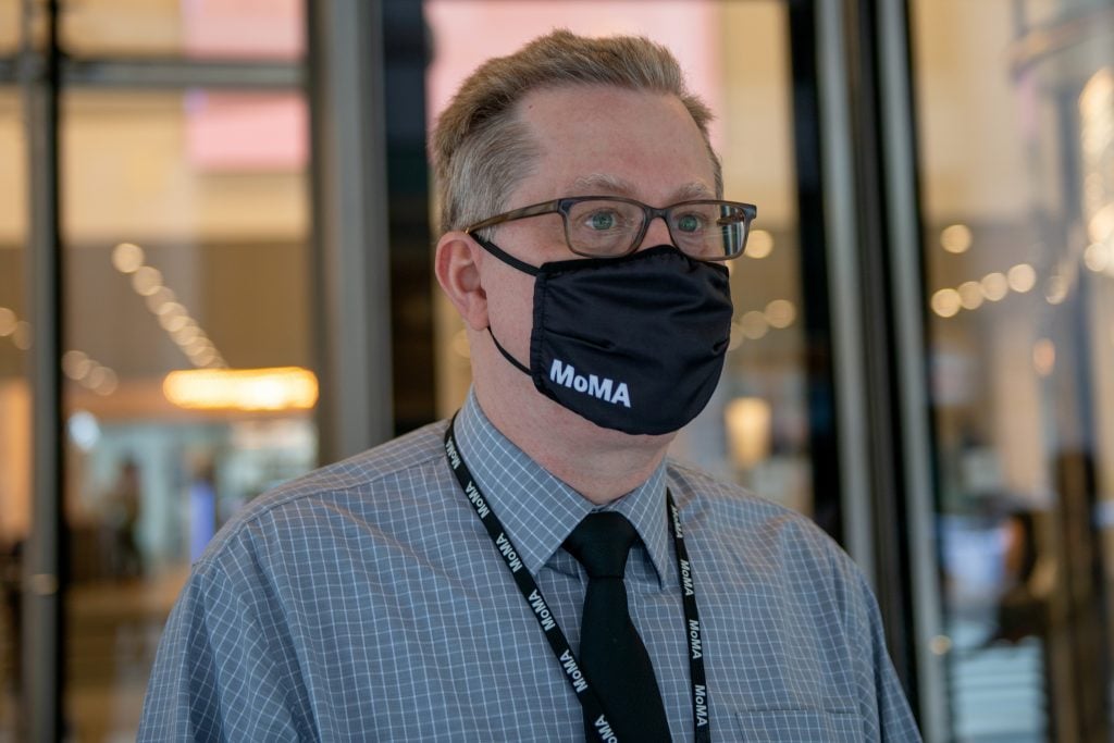 An employee wearing a MoMa mask at the newly reopened Museum of Modern Art in New York City. Photo by Alexi Rosenfeld/Getty Images.