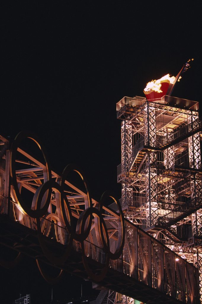 The Olympic flame glows at night in the cauldron designed by Siah Armajani at Atlanta's Centennial Park during the 1996 Olympic Games. Photo by Haslin Frederic/Corbis via Getty Images.