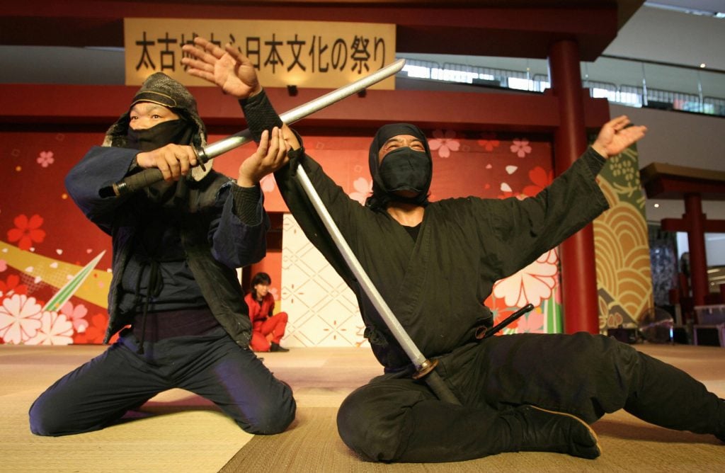 Japanese Iga-ryu Ninjas pose after a performance during a Japanese Cultural Festival in Hong Kong 10 May 2007. (MIKE CLARKE/AFP via Getty Images)