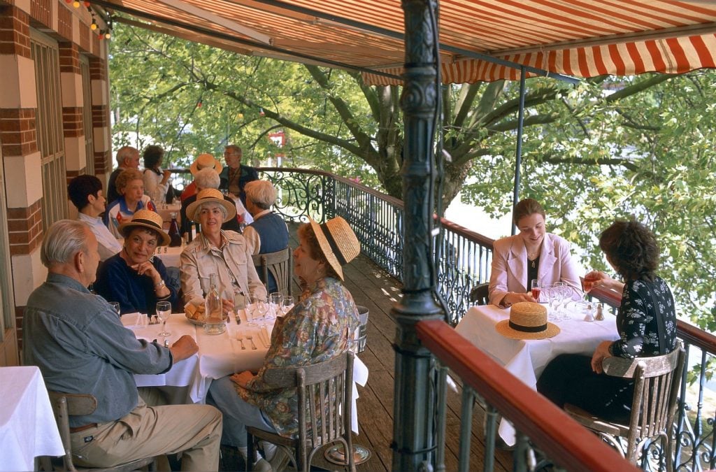 Maison Fournaise, the open-air cafe where Renoir painted The Luncheon of the Boating Party. Photo by Jarry/Tripelon/Gamma-Rapho via Getty Images.