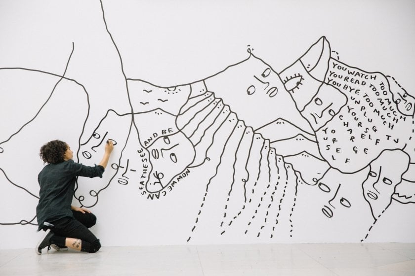 Shantell Martin creating a site-specific mural for the 2017 exhibition "Shantell Martin: Someday We Can." Photograph by Connie Tsang, courtesy of the Albright-Knox Art Gallery, Buffalo.