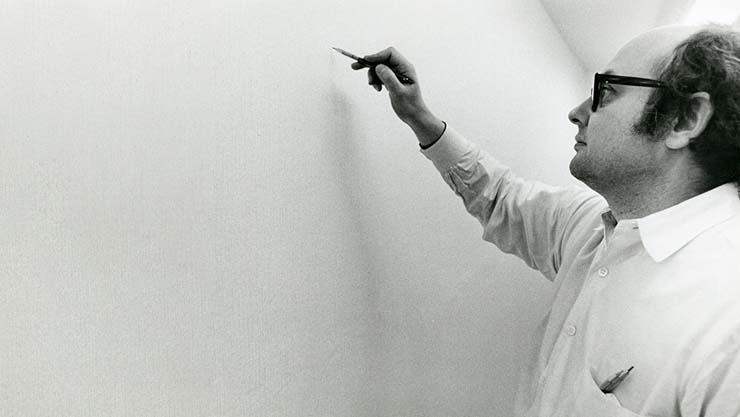 Sol LeWit installing a wall drawing. Photo courtesy of the Sol LeWitt estate.