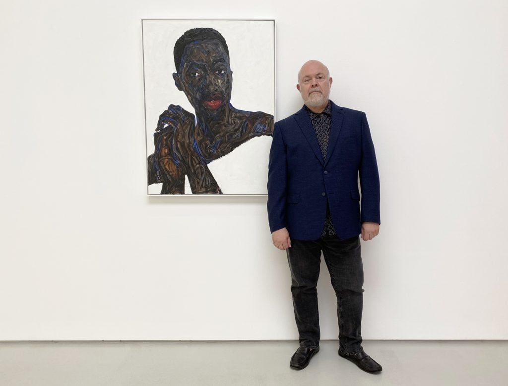 Bennett Roberts with Amoako Boafo's <i>Nuerki</i> (2019). Courtesy of Roberts Projects, Los Angeles.