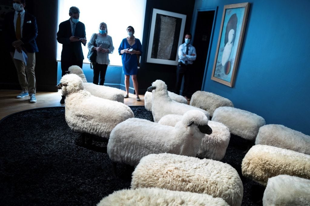 People look at a herd of sheep by François-Xavier Lalanne at the Hotel d'Assezat museum in Toulouse on June 25, 2020. Photo: Lionel Bonaventure/AFP via Getty Images.