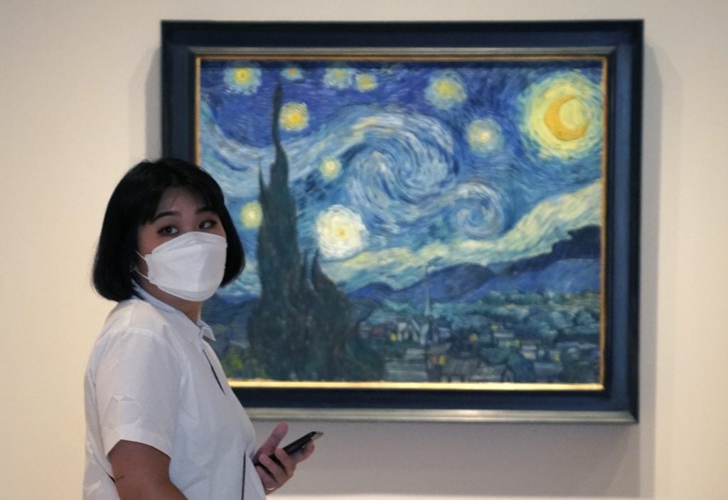 A visitor in front of Van Gogh's Starry Night at MoMA. Photo: TIMOTHY A. CLARY/AFP via Getty Images.