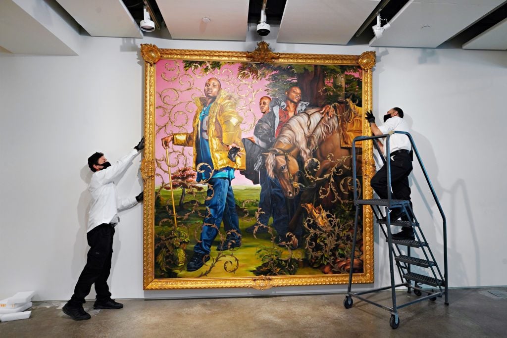 Art handlers prepare Kehinde Wiley's La Roi A La Chasse II at Sotheby's New York. Photo by Cindy Ord/Getty Images).
