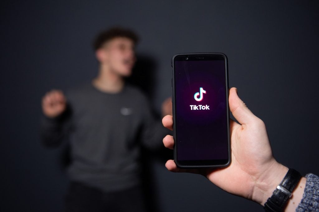 TikTok has become wildly popular with creators—including artists. (Photo by - / AFP via Getty Images)
