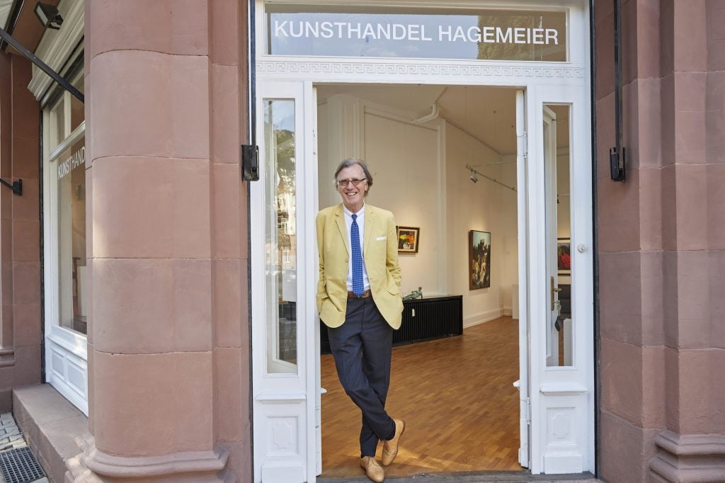 Achim Hagemeier stands at his gallery's entrance.