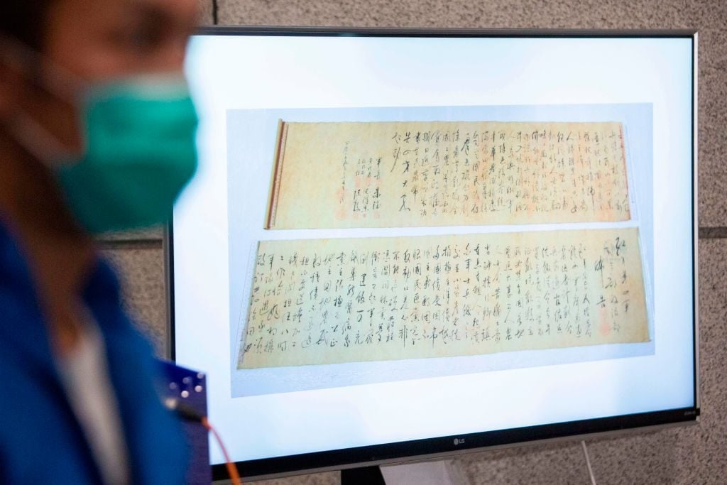 Police show a picture of a calligraphy scroll written by Mao Zedong worth about 300 million USD, that had been recovered but found chopped in half following a robbery that included antique stamps and revolutionary items from mainland China worth an estimated 645 million USD, at a press conference in Hong Kong on October 7, 2020. Photo: Isaac Lawrence/AFP via Getty Images.