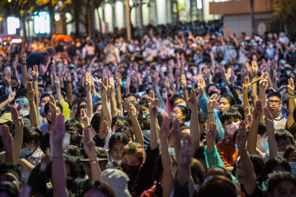Pro-democracy protesters in Thailand making the three-finger salute from The Hunger Games during an anti-government demonstration. Photo by Geem Drake/SOPA Images/LightRocket via Getty Images.
