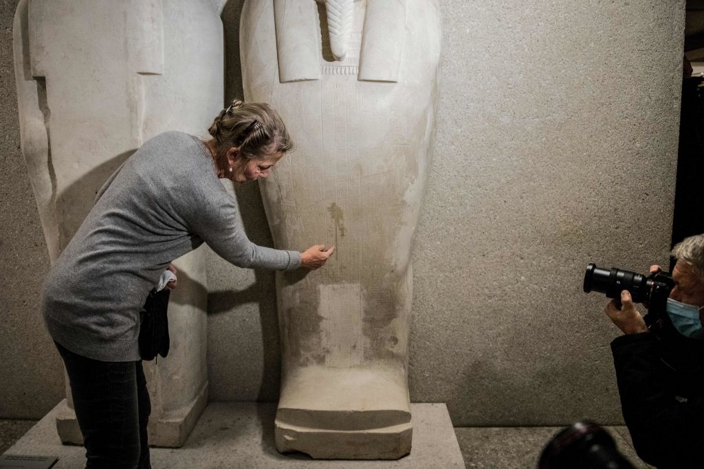 Friederike Seyfried, director of the Egyptian Museum Berlin points to the damage caused by an "oily liquid" that left visible stains on exhibits in the Egyptian part of the Neues Museum. Photo: Stefanie Loos/AFP/Getty Images.