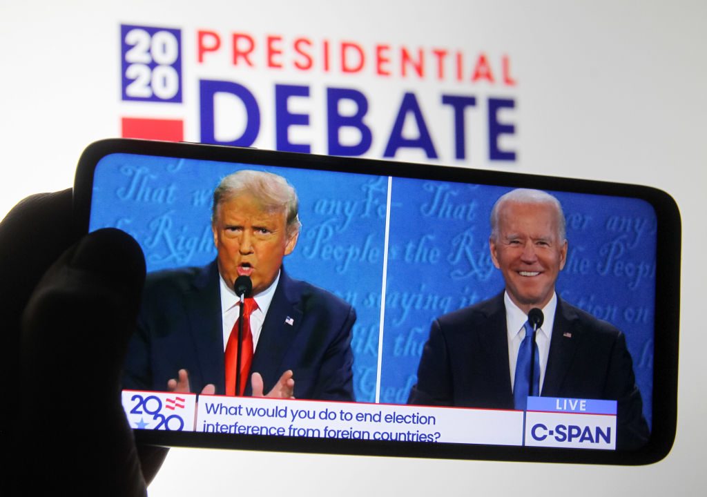 US President Donald Trump and Democratic presidential candidate and former US Vice President Joe Biden are seen during the final presidential debate displayed on a screen of a smartphone. Photo: Pavlo Conchar/SOPA Images/LightRocket via Getty Images.