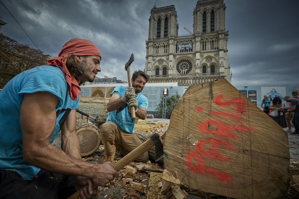 Members of the Charpentiers sans Frontièrs (Carpenters Without Borders) reconstruct with traditional methods one of the missing timber frames of Notre-Dame Cathedral that was destroyed by the fire in front of the Cathedral on September 19, 2020 in Paris, France. Photo by Kiran Ridley/Getty Images.
