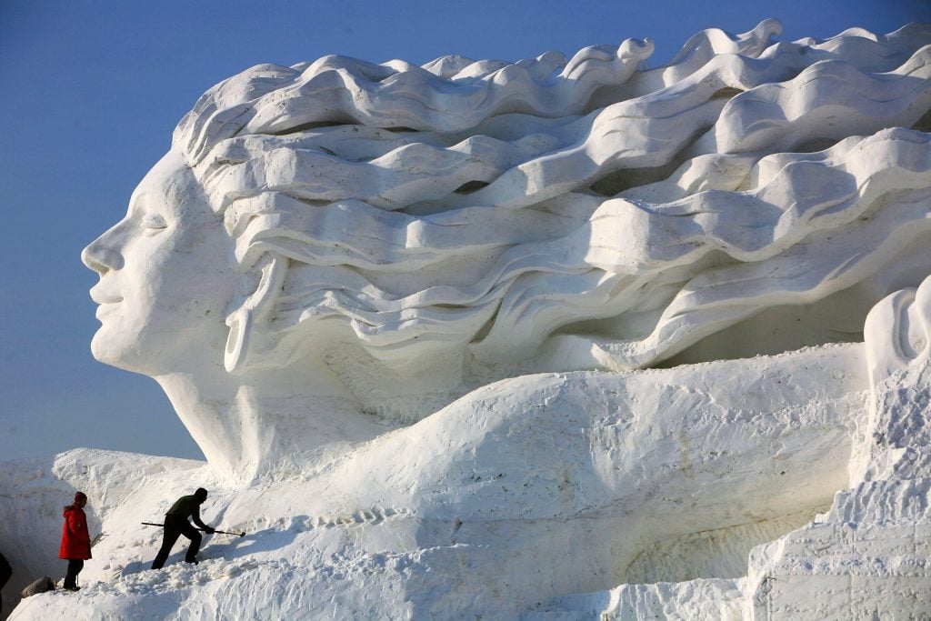 Workers work to make snow sculpture Romantic Feelings at the 20th International Snow Sculpture Art Expo on December 17, 2007 in Harbin of Heilongjiang Province, China. Photo by China Photos/Getty Images.