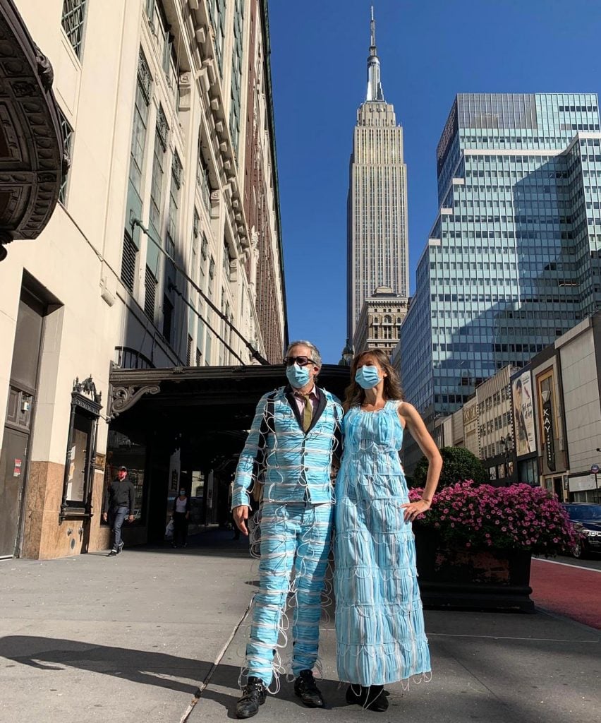 Adrian Wilson and Heidi Hankaniemi, <em>Wear a Mask</em>, in front of the Empire State Building. Photo by Tudor Vasilescu.