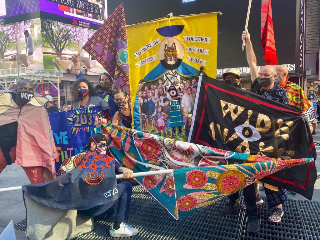 Michele Pred's Vote Feminist March in Times Square for the Wide Awakes. Those picturred include Tracey Ryans, Nour Batyne, Yvette Molina, Pablo A. Medina, and Craig Dykers in the back row, and Jose Parla in front. Photo by Sarah Cascone. 