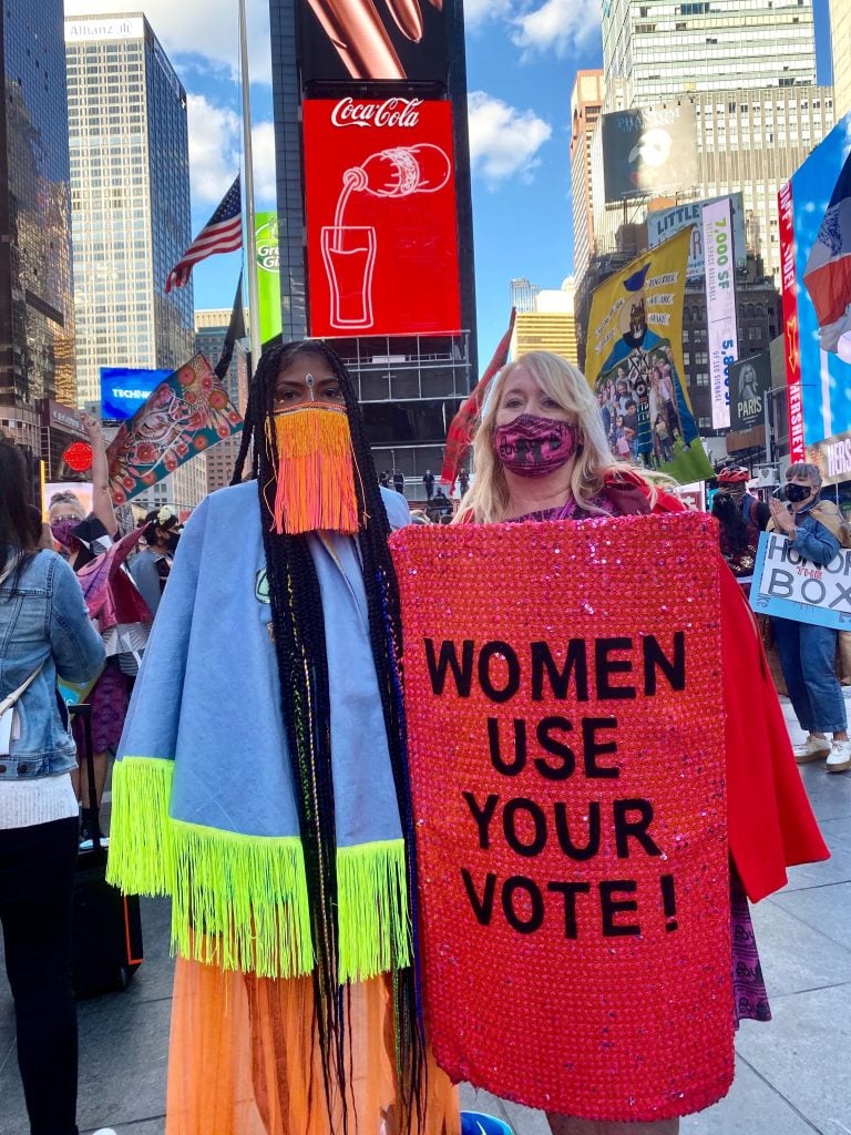 Ebony Brown and Michele Pred leading the Vote Feminist March in Times Square for the Wide Awakes. Photo by Sarah Cascone.