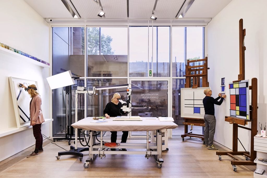 Conservators at the Fondation Beyeler at work on paintings by Piet Mondrian. Photo courtesy Fondation Beyeler and La Prairie.
