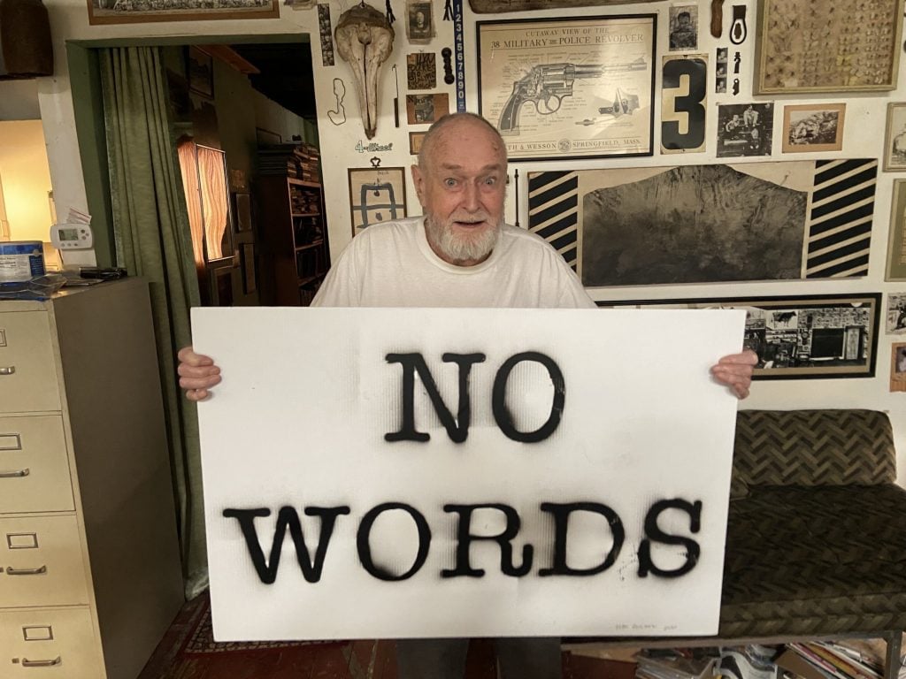 Lyn Foulkes with his sign <em>No Words</em> for the “Show Me the Signs” auction. Photo courtesy of the African American Policy Forum.