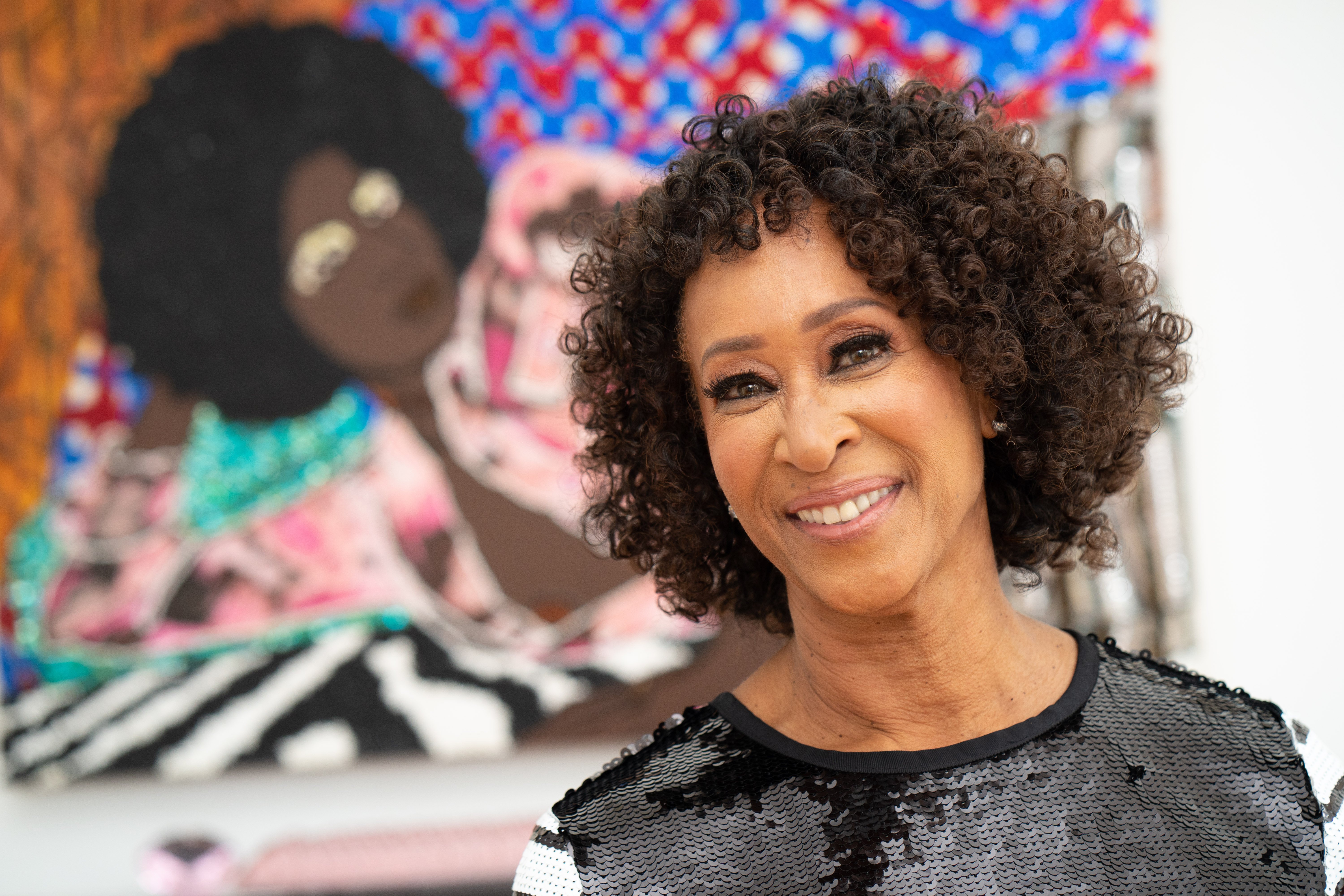 Dr. Joy Simmons in front of Mickalene Thomas's "Look at What You've Become" (2005). Photo by Leroy Hamilton.