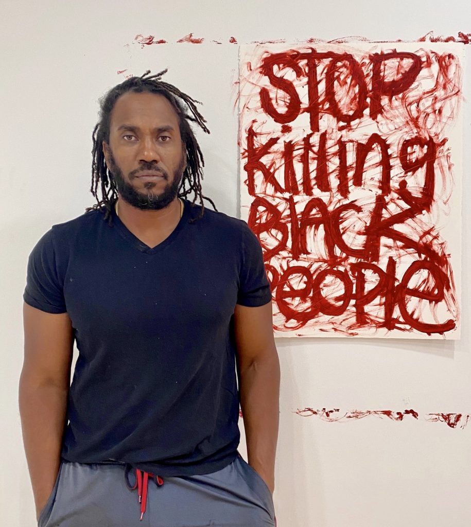 Rashid Johnson with his painting <em>Untitled</em> for the “Show Me the Signs” auction. Photo courtesy of the African American Policy Forum.