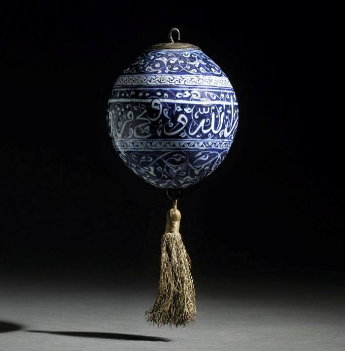 An early Iznik blue and white calligraphic pottery hanging ornament, Turkey, circa 1480. Courtesy of Sotheby's.