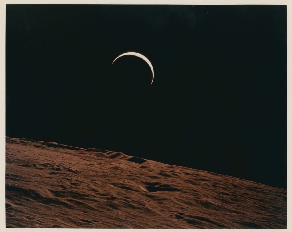Alfred Worden, Crescent Earth rising beyond the Moon’s barren horizon. Apollo 15, July 26 - August 7, 1971, orbit 70. Courtesy of Christie's Images Ltd.