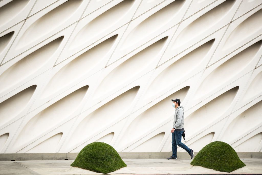 A pedestrian wearing a face mask is seen in front of The Broad museum during the coronavirus pandemic on April 08, 2020 in Los Angeles, California. Photo: Rich Fury/Getty Images.