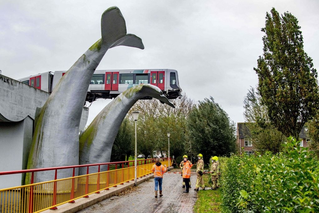 An photo taken in Spijkenisse, on November 2, 2020 shows a metro train that shot through a stop block at De Akkers metro station, without making any casualty. It was prevented from plummeting into water by a sculpture of a whale tail called, improbably, Saved by the Whale's Tail. Photo by Robin Utrecht/ANP/AFP/Netherlands OUT via Getty Images.