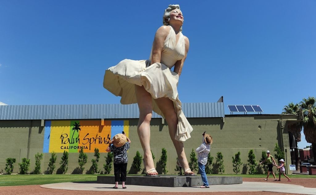 People visit and photograph the Forever Marilyn statue of actress Marilyn Monroe in Palm Springs, California, on August 4, 2012, a day ahead of the 50th anniversary of Monroe's mysterious death. Photo: Frederic J. Brown/AFP via Getty Images.