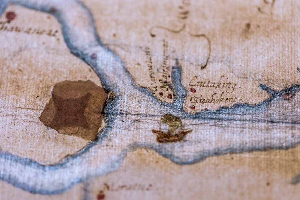This 16th-century map of what is now coastal North Carolina appears to show a fort concealed under a patch and visible only by backlighting that may have been where survivors settled after abandoning Roanoke Island. Photo by Stuart Conway, courtesy of the trustees of the British Museum.