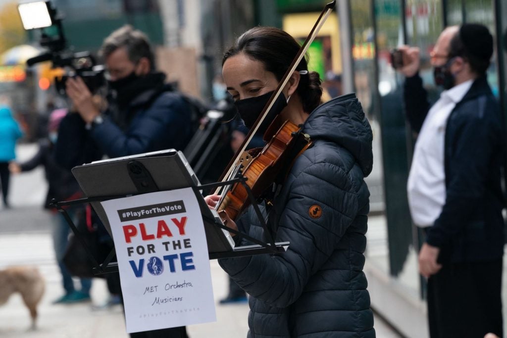 Metropolitan Opera Orchestra musicians perform classical music for Upper West Side voters outside the David Rubenstein Atrium at Lincoln Center on Election Day, November 3, 2020 in New York. (Photo by BRYAN R. SMITH/AFP via Getty Images)