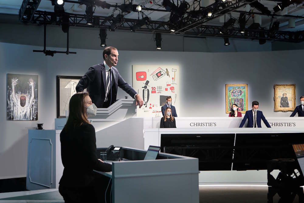 Adrien Meyer on the rostrum during the New York portion of Christie's December 2 relay sale. Image courtesy Christie's.