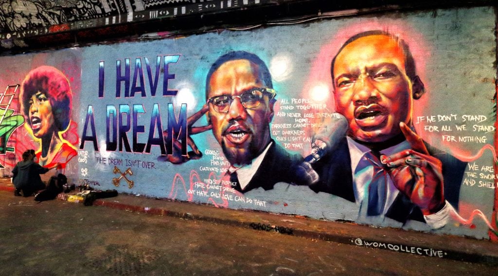 Street art of Martin Luther King and Malcolm X made in reference to the George Floyd killing at the famous Leake Street Tunnel under Waterloo station. Photo by Keith Mayhew/SOPA Images/LightRocket via Getty Images.
