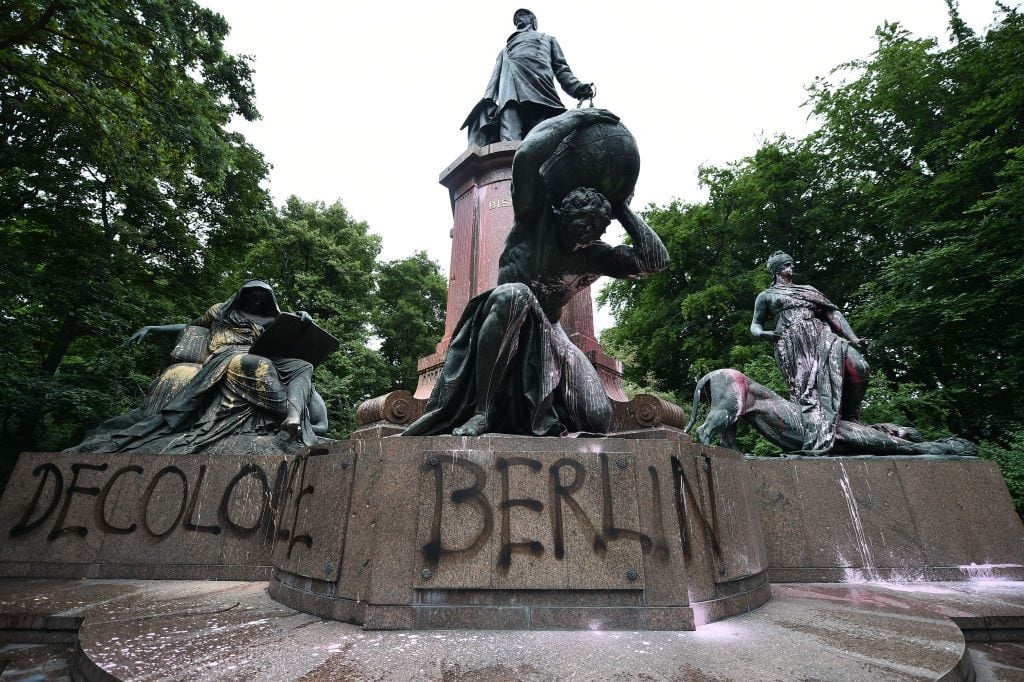 "Decolonize Berlin" is sprayed on the Bismarck National Monument in Berlin which is smeared with paint. Photo by Sven Braun/picture alliance via Getty Images.