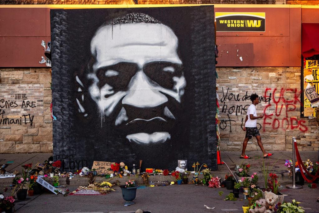 A large black and white mural of George Floyd's face stands tall on the sidewalk outside of Cup Foods near where Floyd was killed on Sunday, July 26, 2020 in Minneapolis. Photo by Jason Armond/Los Angeles Times via Getty Images.