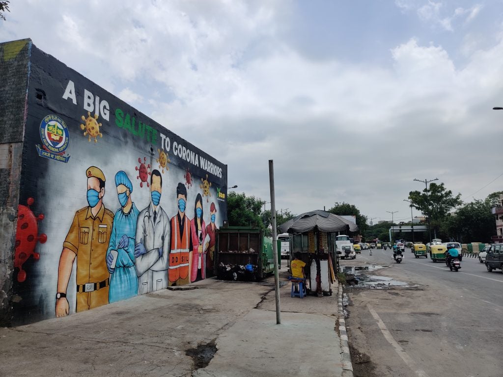 Street art adorning a public wall depicting and honoring front line corona warriors which includes, health care workers, police personnel, journalists, and sanitary workers on July 11, 2020 on the wall of municipal compactor in New Delhi, India. Photo by Pallava Bagla/Corbis via Getty Images.