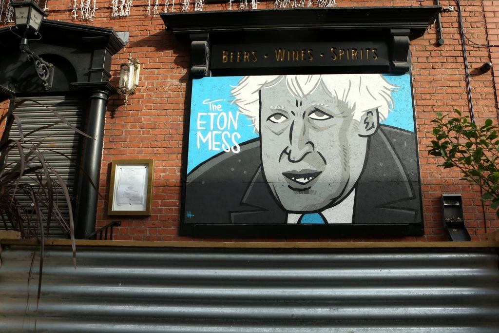 Street art depicting Boris Johnson which reads "The Eton Mess" is seen at the Bay Horse Tavern in Manchester's Northern Quarter on November 09, 2020. Photo by Charlotte Tattersall/Getty Images.