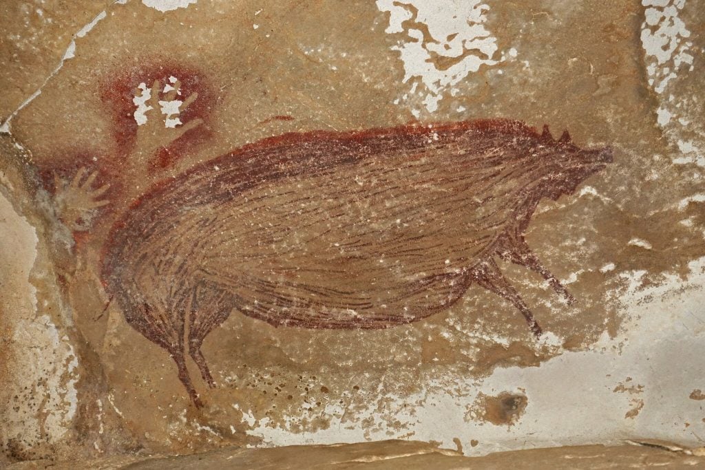 This painting of a wild pig in the Leang Tedongnge cave on the Indonesian island of Sulawesi is thought to be the oldest representational art in the world. Photo by Maxime Aubert.