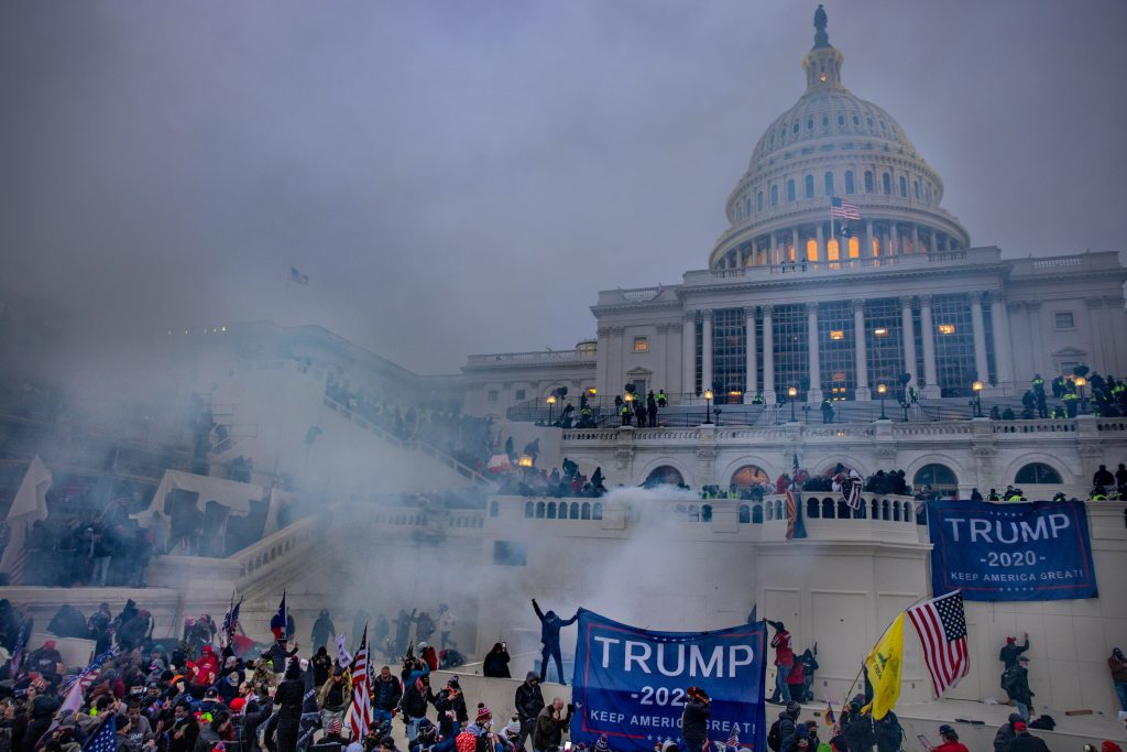 Tear gas is fired at supporters of President Trump who stormed the United States Capitol building. Photo by Evelyn Hockstein for the Washington Post.