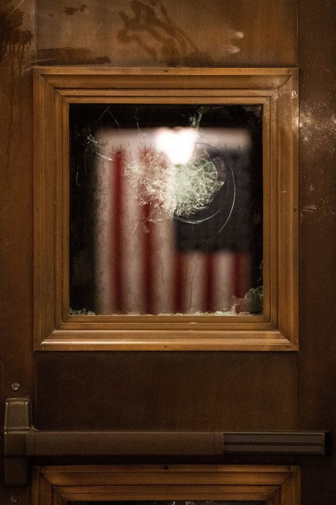 A shattered window pane in the aftermath of a pro-Trump invasion of the US Capitol in Washington, DC. Kent Nishimura / Los Angeles Times via Getty Images.