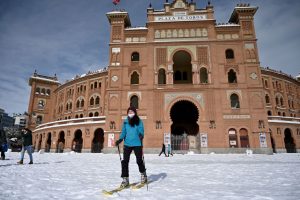 A woman skis outside the Las Ventas bullring in Madrid on January 10, 2021. Photo by Gabriel Bouys/AFP via Getty Images.