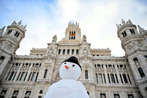 A snowman is built outside the Cibeles Palace in Madrid on January 10, 2021. Photo by Gabriel Bouys/AFP via Getty Images.