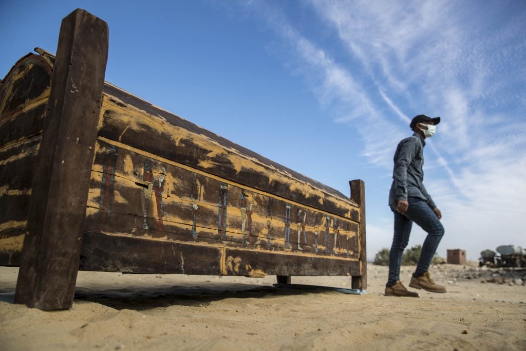 An adorned wooden sarcophagus is displayed during the official announcement of the discovery. (Photo by KHALED DESOUKI/AFP via Getty Images)