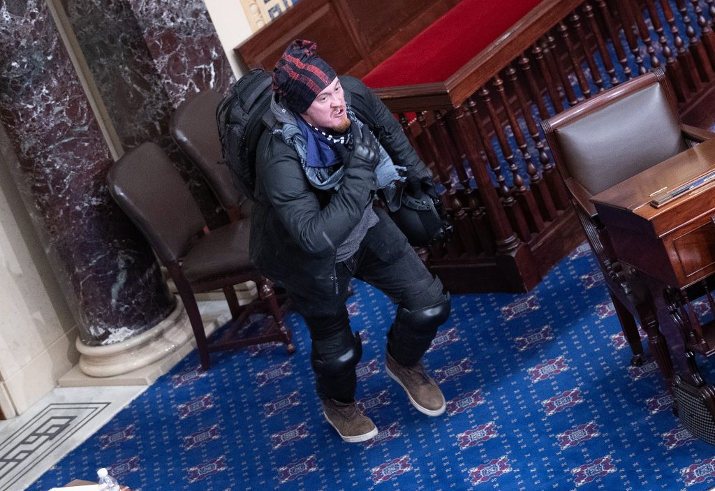 A protester supporting President Donald Trump moves to the floor of the Senate chamber at the U.S. Capitol Building on January 06, 2021. Photo by Win McNamee/Getty Images.
