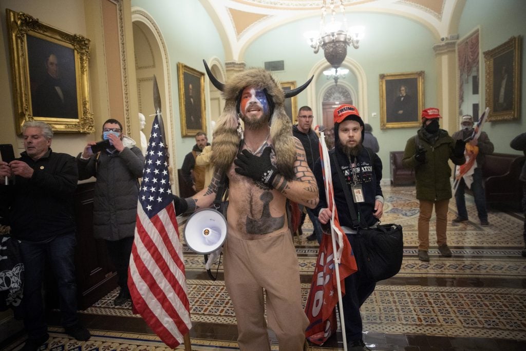 A pro-Trump mob confronts US Capitol police outside the Senate chamber of the U.S. Capitol Building on January 06, 2021 in Washington, DC. Photo by Win McNamee/Getty Images.