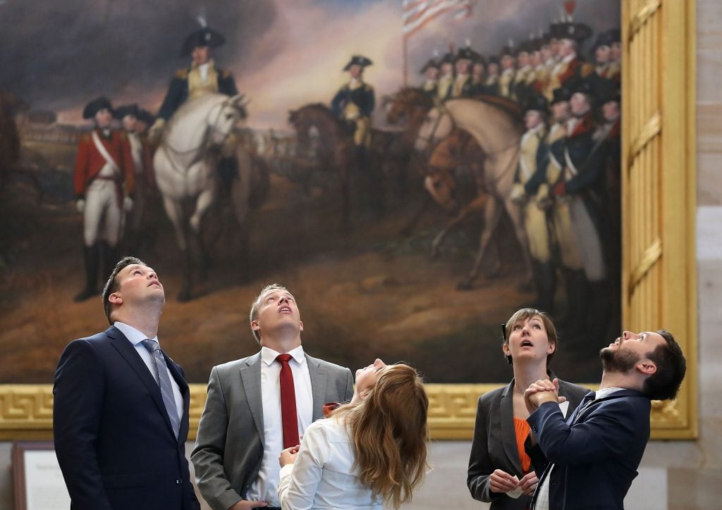 People look up at the ceiling of the newly restored rotunda inside the US Capitol, September 6, 2016 in Washington, DC. (Photo by Mark Wilson/Getty Images)