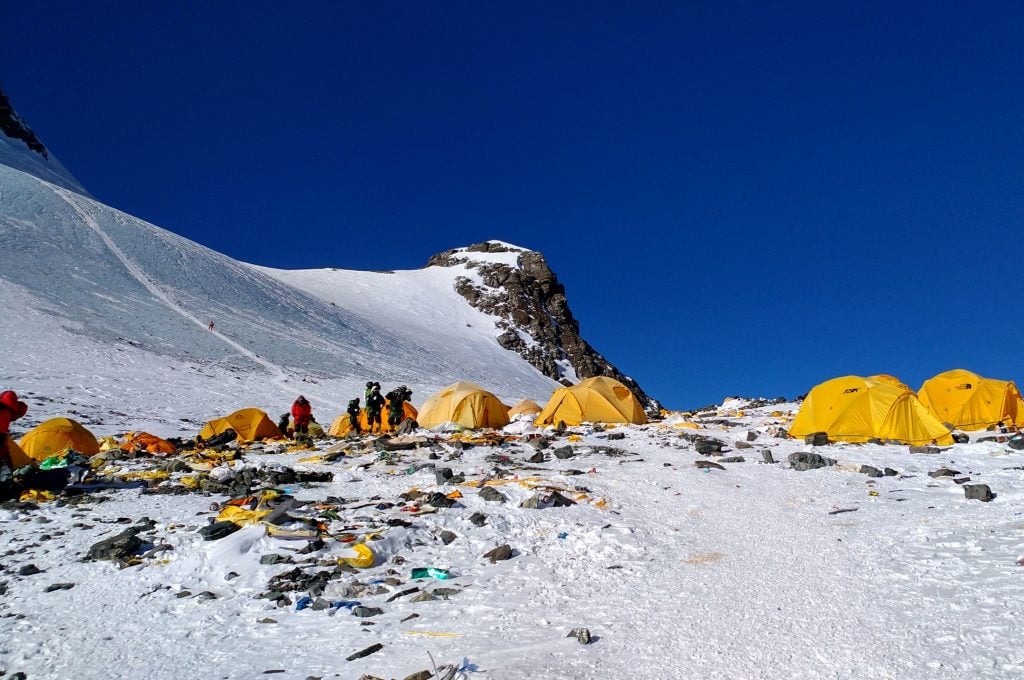 Discarded climbing equipment and rubbish scattered around Camp 4 of Mount Everest. Photo: DOMA SHERPA/AFP via Getty Images.