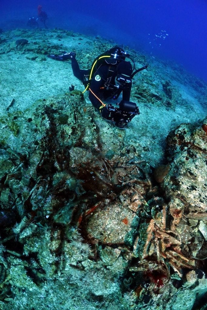 A diver investigates amphorae from a ship that sunk off Kasos island. Photo courtesy of the Kasos Maritime Archaeological Project.
