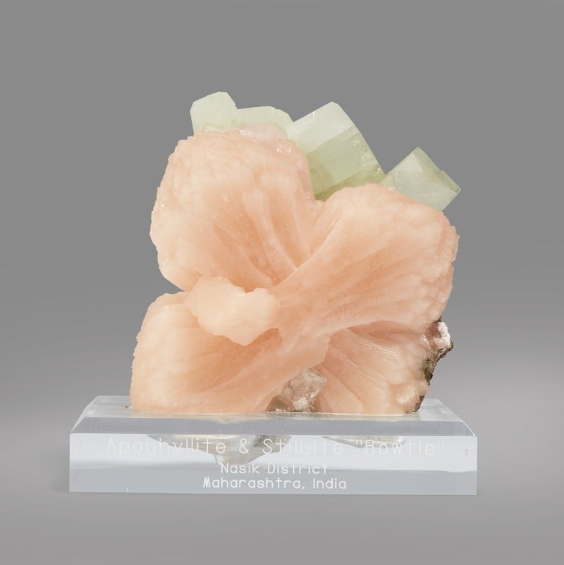A doubly terminated green apophyllite crystal with overgrowth of pink stilbite and additional apophyllite. But you already knew that. Photo courtesy Sotheby's.